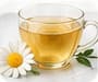 A cup of herbal tea with a chamomile flower